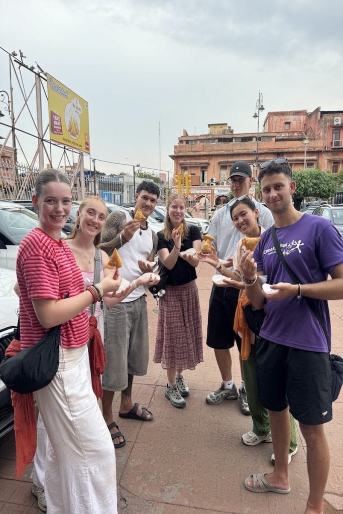 Guests enjoying samosas during a Jaipur Heritage Walk and street food tour
