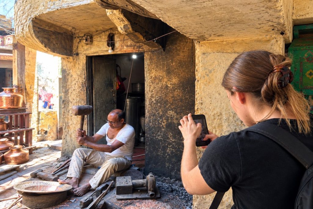 Traveller watching a local artisan during a Jaipur cultural experience