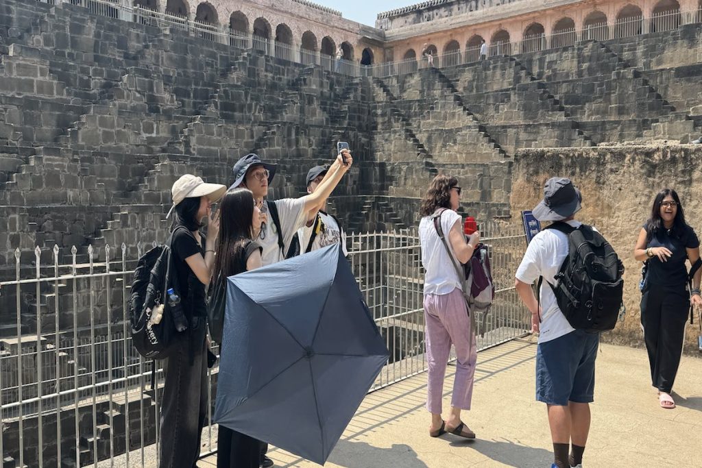 Travellers exploring Chand Baori stepwell in Abhaneri during a Golden Triangle tour