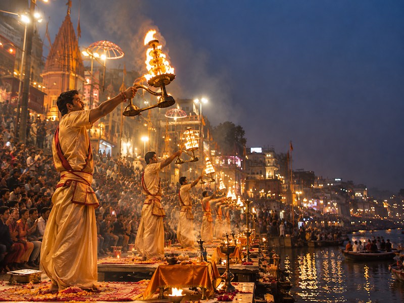 Historic ghats, temples and boats along the River Ganges in Varanasi, India.